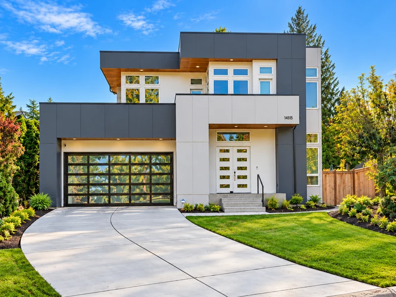 Contemporary Redmond home with a glass garage door, wood soffits and landscaped front yard