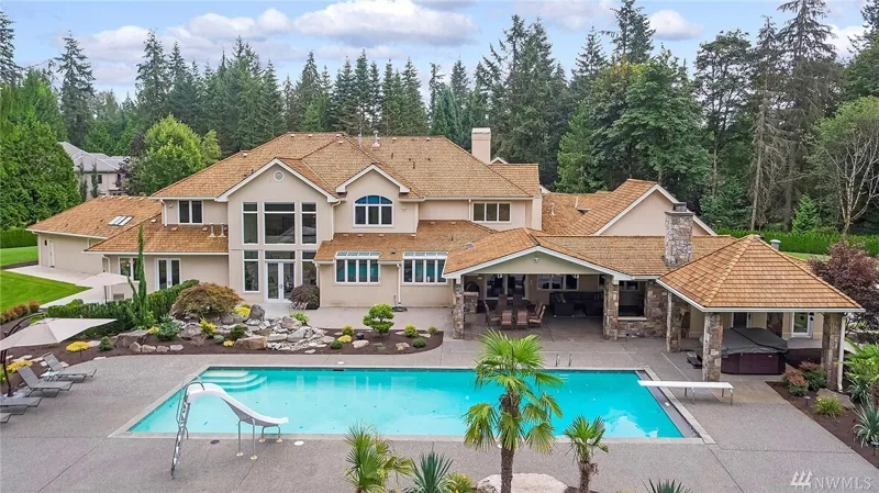 Rear view of the home, pool and covered outdoor rooms